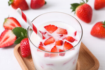 Delicious drink with strawberries on white table, closeup