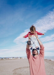 Young dad have a great day at the beach with his dauther