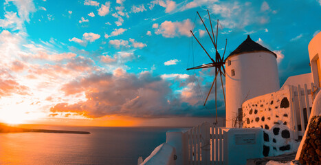 Windmill in Oia village on Santorini island during sunset