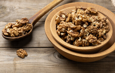 peeled walnuts in a wooden plate on the table