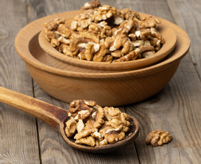 peeled walnuts in a wooden plate on the table