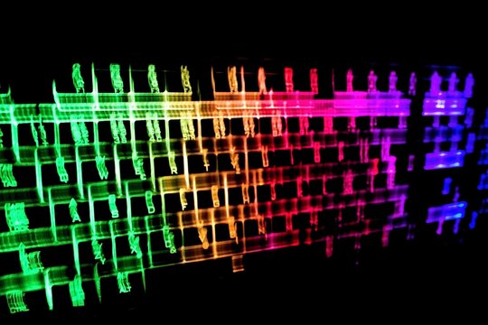 Abstract background created by blur glowing keyboard.Rainbow concept for modern technology, gaming and colorful light shows.