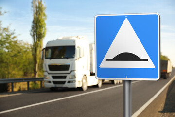 Sign Speed Bump near asphalt road outdoors