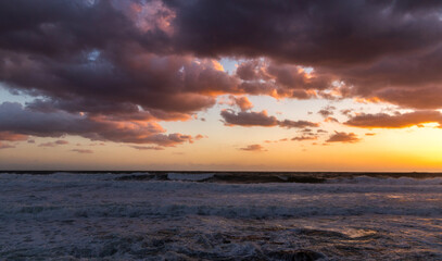 Cloudy sunset at the stormy sea.