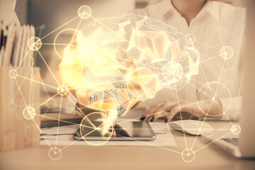 Double exposure of brain sketch hologram and woman holding and using a mobile device.