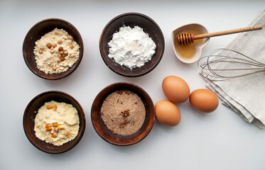 Ingredients for making gluten-free dough. Four types of flour: corn, chickpea, rice, buckwheat, eggs and honey. Making gluten free bread.