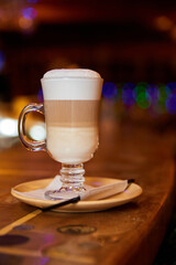 Glass of hot Latte coffee on the bar. Close-up, selective focus