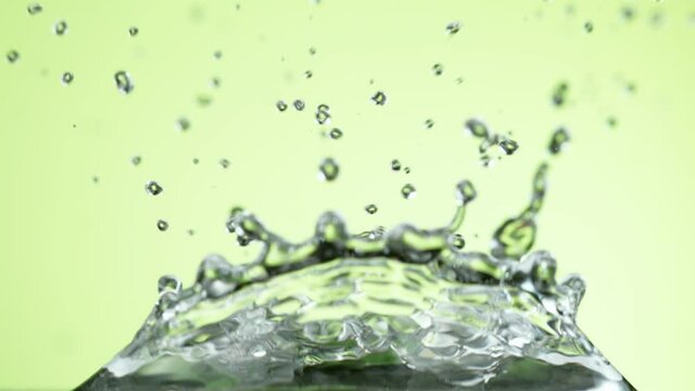 Super slow motion of falling lime slice into splashing water. Filmed on high speed cinema camera, 1000 fps.