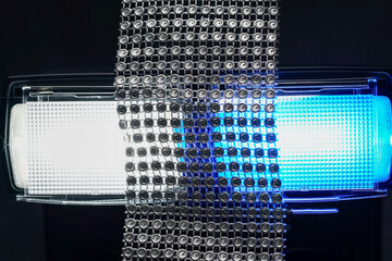 Flash light of a camera with colorful color foils photographed in the studio