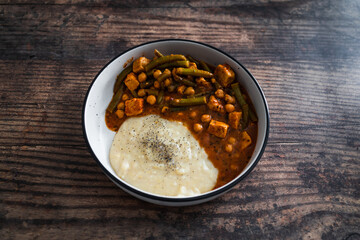 vegan chickpea green beans stew with tofu cubes and mashed potato, healthy plant-based food