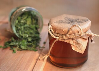 healthy delicious mint syrup in a jar with dry mint leaves on a beige background
