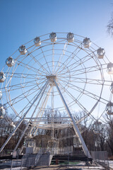 Ferris wheel in the park against the blue sky