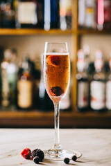 glasse of champagne with raspberry on a table in a cafe