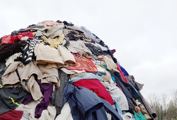 large pile stack of textile fabric clothes and shoes. concept of recycling, up cycling, awareness...
