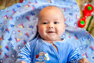 A newborn baby is resting in bed. Children's room. Textiles and bedding for children. Family morning at home. image with selective focus