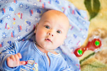 A newborn baby is resting in bed. Children's room. Textiles and bedding for children. Family morning at home. image with selective focus