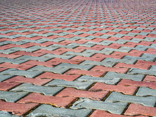 Red gray paving stones texture. High angle view. Perspective.