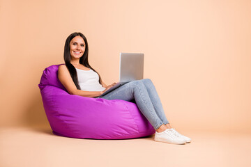 Full size profile photo of optimistic brunette girl sit pouf type laptop wear white top jeans...