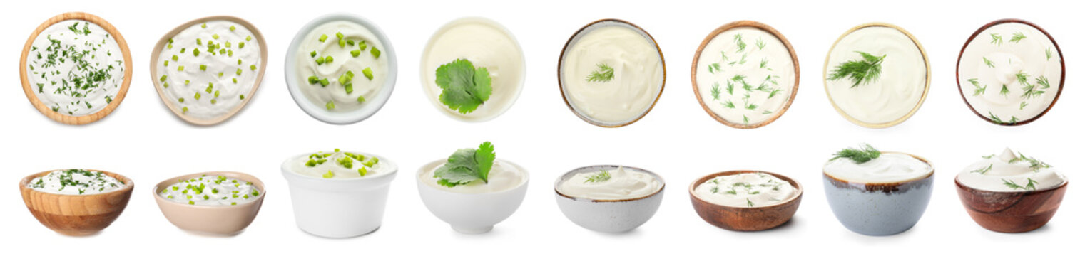 Bowls of tasty sour cream with herbs on white background