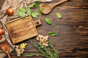 Cutting board with herbs and spices on wooden background