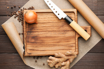 Cutting board with spices on wooden background
