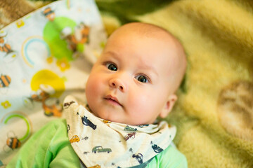 Infant baby posing in bib, image with selective focus