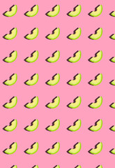 Vertical pattern with avocado slices on a pink background.