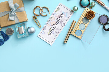 Gift certificate, decorative cosmetics and female accessories on color background