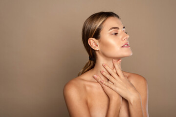 Lovely young woman touches her neck. Beautiful woman cares for the skin neck. heath and beauty concept