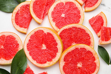 Fresh sliced grapefruit on light background