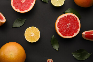 Fresh citrus fruits on dark background