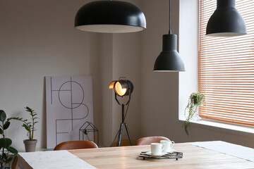Interior of modern room with table and lamps