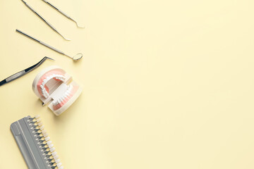 Fototapeta premium Dentist's tools, jaw model and teeth samples on color background