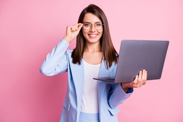 Photo of young business woman happy smile confident hold laptop hand touch glasses isolated over pink color background