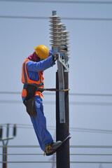 Worker Installing Electric Poles
