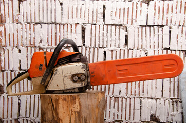 Chainsaw with traces of operation and a protective cover on the chain right side view