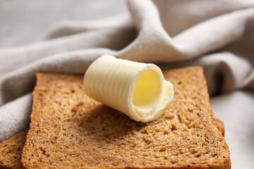 Slices of fresh bread with butter on table, closeup