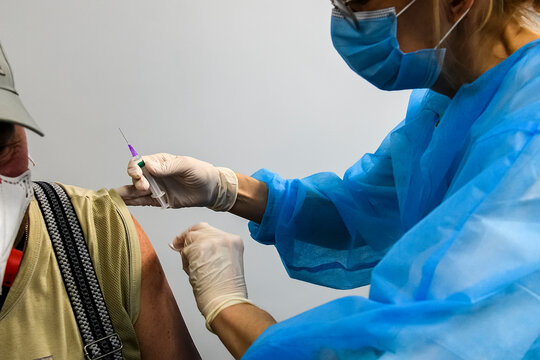 Close Up Of The Hands Of A Healthcare Worker Who Vaccinates An Elderly Person With A Coronavirus Vaccine. 