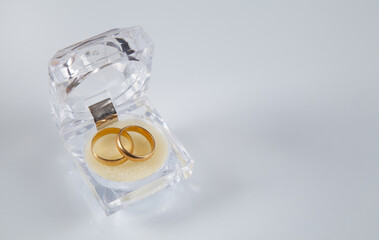 Box with wedding rings, white background.