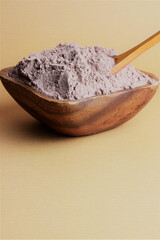Bowl full of cocoa powder. Close up, copy space.