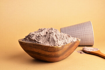 Bowl full of cocoa powder. Copy space.