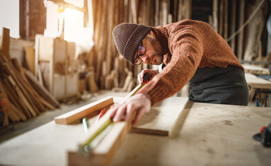 Joiner working with wooden detail in workshop