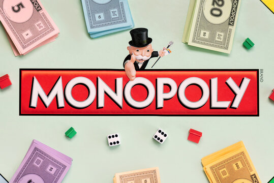 Monopoly gameboard with money bills,dice and houses