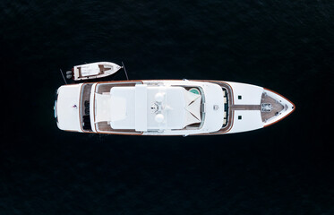 High angle aerial bird's eye view of a long white luxury yacht with wooden deck, a jacuzzi and a...