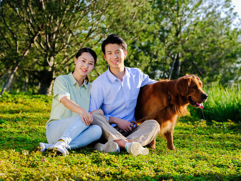 Young couple and pet dog in the park