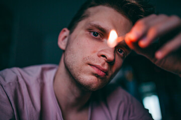 close-up of the face of the guy who lit the match