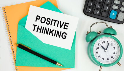 Card on a postal envelope with the text Positive Thinking