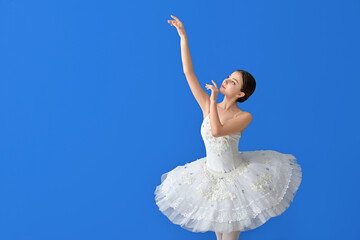 Beautiful young ballerina on color background © Pixel-Shot