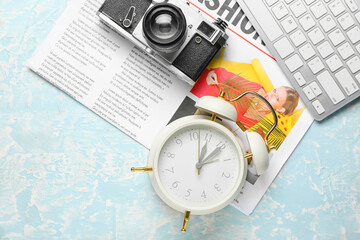 Composition with alarm clock, photo camera and computer keyboard on color background