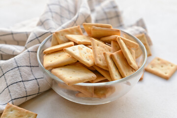 Bowl of crackers on light background